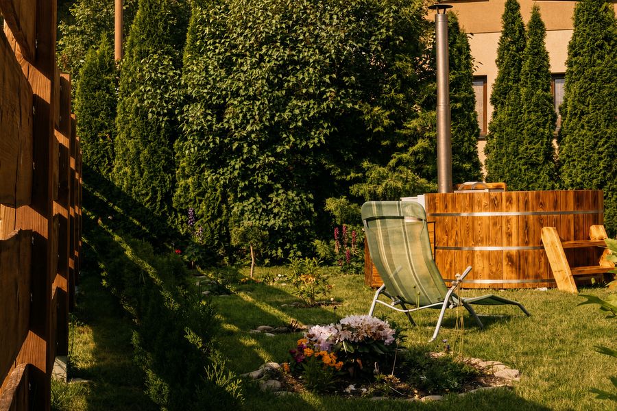 Wooden hot tub in the garden in summer