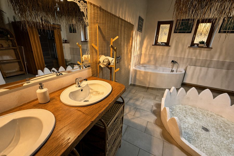 Bathroom with a double basin, a bath and a flower-shaped shower