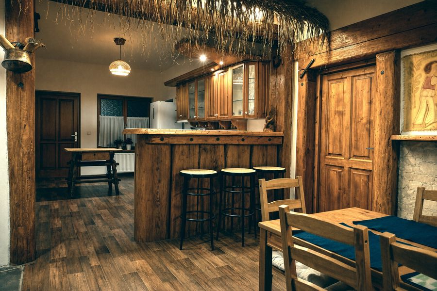Bar with stools under a thatched canopy