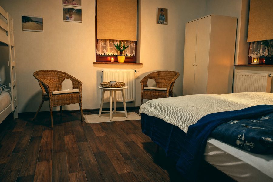 Bedroom with a double bed and wicker chairs