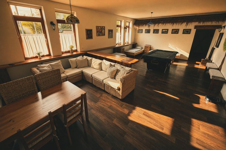 The whole living room with a sofa and a billiard table