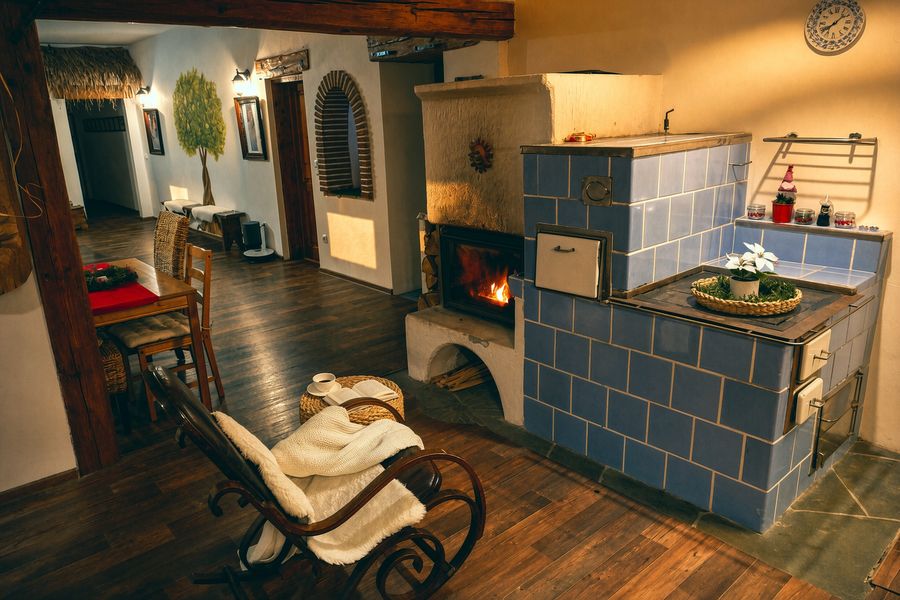 The tiled stove and a rocking chair seen from the hallway