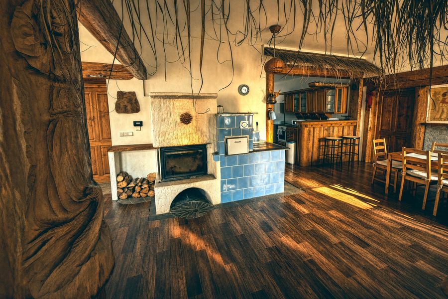 Carved wooden pillar and the blue tiled stove