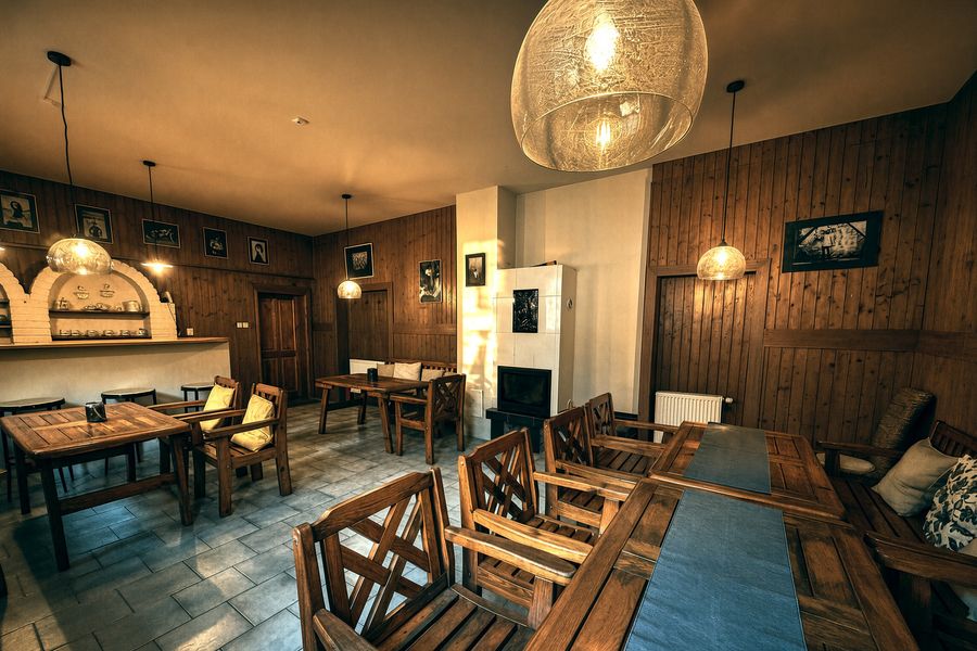 The Latte lounge with a fireplace and tables